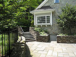 stone paving and steps connect the guesthouse to the pool level