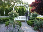 two arbors at the sides with benches and vines