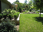 new retaining wall at left house front to create level area