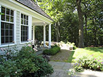 a brick walk connects the large terrace with the porch
