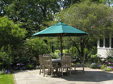 dining table with umbrella on the large bluestone terrace