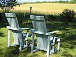 two chairs overlooking farm hillside