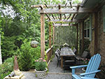 upper gravel terrace with dining pergola