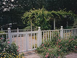 gate and fence between pool and herb garden